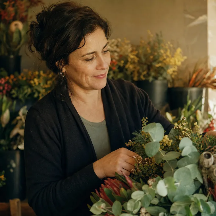 A florist arranging flowers in her shop